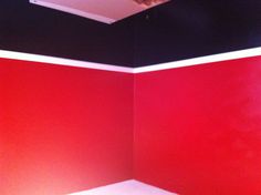 a room painted red and black with white trim