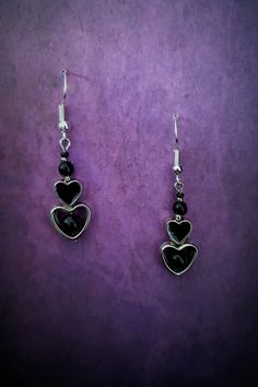 Introducing our stunning Gothic Black Heart Dangle Earrings! These captivating earrings are the perfect accessory for those with a dark and mysterious edge. Crafted with exquisite attention to detail, each earring features a beautifully intricate black heart design, symbolizing passion and intensity. These earrings are lightweight and comfortable to wear, ensuring you can showcase your unique style all day long. Whether you're dressing up for a Gothic-inspired event or simply want to make a statement, these earrings will add a touch of allure and sophistication to any ensemble. Embrace your inner darkness with our Gothic Black Heart Dangle Earrings and let them be a reflection of your unique personality. Each product is one of a kind so there might be slight variations in colour, thickness Dark Feminine Earrings, Gothic Metal Earrings For Valentine's Day, Black Dangle Jewelry For Valentine's Day, Black Sterling Silver Heart Earrings, Gothic Dangle Earrings For Valentine's Day, Black Heart-shaped Pierced-style Jewelry, Black Metal Jewelry For Valentine's Day, Black Drop Earrings For Valentine's Day, Valentine's Day Black Metal Jewelry