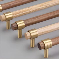 four different sized wooden poles with brass fittings