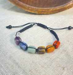 "Free Shipping when you spend $35 at Moondance Trading. Our Products are the same as shown in the pictures. We do not use substitute images. Shapes, sizes, and colors may slightly vary. Everything ships directly from our studio in Orlando, FL. USA Made with Genuine Chakra Crystals: Jasper, Carnelian, Tiger Eye, Aventurine, Sodalite, Amethyst, Clear Quartz. These adjustable unisex bracelets fit best 7.5\" to 9\" wrist sizes. Size, color and shape of the bracelets may slightly vary. * Healing Info Adjustable Multicolor Crystal Bracelet For Healing, Adjustable Multicolor Natural Stone Friendship Bracelets, Adjustable Multicolor Friendship Bracelets For Healing, Handmade Adjustable Multicolor Crystal Bracelet, Adjustable Multicolor Round Beads Crystal Bracelet, Adjustable Multicolor Bracelets For Meditation, Adjustable Crystal Bracelet With Stones For Meditation, Adjustable Bohemian Crystal Bracelet With Stones, Adjustable Stone Beaded Bracelets For Meditation