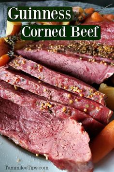 sliced corned beef and carrots on a white plate with the words guinness corned beef