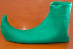 a green sock sitting on top of a wooden table