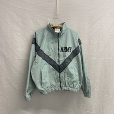 Medium / Vintage US Army PFU Jacket Reflective Nylon Full Zip Jacket Pit to Pit: 26in Top Collar to Bottom: 26in Sleeve Length: 35in Please take the time to review our shop policies listed on our homepage before purchasing. We do NOT accept returns, but will gladly accept exchanges. All items are vintage, and sold AS IS. Thank you for shopping with us! - RatRunners Green Nylon Military Outerwear, Military Long Sleeve Nylon Outerwear, Military Style Long Sleeve Nylon Outerwear, Khaki Nylon Track Jacket For Winter, Military Style Green Windbreaker For Spring, Green Military Style Windbreaker For Spring, Fall Military Nylon Outerwear, Military Nylon Windbreaker For Fall, Khaki Nylon Track Jacket For Fall