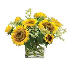 a vase filled with lots of yellow sunflowers