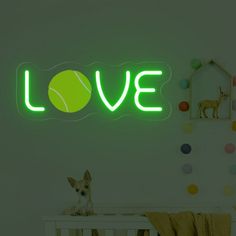 a neon sign that says love with a dog sitting in the crib next to it