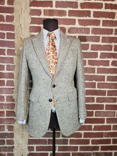 Good vintage condition.  Grey tan herringbone tweed Harris Tweed Textured wool Size 38R Fabric wool tweed Shoulders 17 Chest 40 CB length 30 Arm/Sleeve, cuff to shoulder seam 25 Semi-formal Notch Lapel Tweed Jacket, Formal Tweed Sport Coat For Fall, Classic Tweed Sport Coat With Herringbone Pattern, Classic Tweed Sport Coat For Business Casual, Semi-formal Tweed Sport Coat With Herringbone Pattern, Classic Tweed Sport Coat For Semi-formal Occasions, Formal Tweed Sport Coat With Notch Lapel, Tailored Herringbone Sport Coat For Semi-formal Events, Dapper Semi-formal Tweed Jacket With Notch Lapel