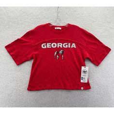 New '47 Brand Georgia Bulldogs Uga Crop Top T-Shirt Women's Small This Has A Nice Relaxed Draped Fit, You May Be Able To Comfortably Size This Up To A Medium Just Double Check Your Measurements Prior To Purchase New With Tags In Excellent Condition Measurements Are Posted For You To Look At Within The Listing Photos Enjoy Lightning Fast Shipping Message Response Times I Ship Items Every Day, You Can Expect Your Order To Be Sent Out Within 1 Business Day And Tracking Provided Browse Our Store To Red Sporty Tops For College, Sporty Red Tops For College, Red Varsity Streetwear Top, Red Varsity Top For Streetwear, Red Cotton Tops With Team Logo, Casual Relaxed Fit Tops With Team Logo, Casual Red Tops For Game Day, Red Varsity Sports Top, University Red Top With Graphic Print For Sports Season