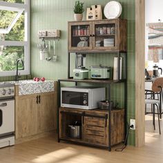 a kitchen with green walls and wooden floors