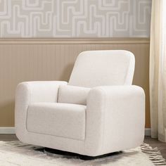 a white chair sitting on top of a rug