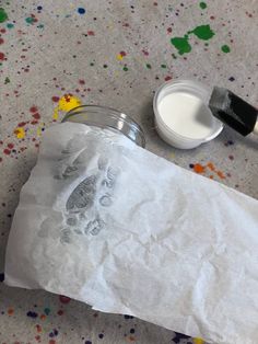 a paint can and some paper on the floor