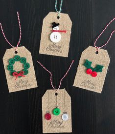 three tags with christmas decorations on them hanging from twine string, one has a snowman and the other has a wreath