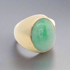 Experience the timeless elegance of our Oval Cabochon Jade and 14K Yellow Gold Vintage Ring. The smooth cabochon jade and bold gold setting exude sophistication and luxury. Elevate any outfit with this classic, vintage piece that will never go out of style. Jewelry Style : Ring Metal Type : 14K Gold  Jade: Oval approximately 17mm x 13mm Ring Size : 9.5 : Can be sized by your jeweler estate piece, sold as is, all weights are estimates Luxury Oval Elegant Cabochons, Luxury Vintage Cabochon Jewelry, Gold Vintage Ring, Art Deco Diamond Rings, Zodiac Pendant, Jewelry Style, Ring Metal, Monogram Gifts, Vintage Engagement