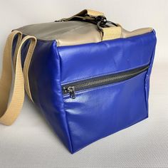 Travel in style with our stylish and spacious duffle bag! From upcycled Southwest Airlines leather our expert artisans handcraft each bag for maximum quality. Tan leather and Southwest's signature Canyon Blue complement one another, creating a chic travel bag. We know how hard it can be to fit everything you need into one bag when traveling. Here's to better packing! This bag is made from upcycled leather from Southwest Airlines seat covers which have been cleaned and refurbished prior to being Airline Seats, Southwest Airlines, Upcycled Leather, Leather Duffle Bag, Leather Duffle, Travel In Style, One Bag, Gorgeous Bags, Leather Seat