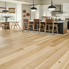 an open kitchen and dining room with hardwood floors