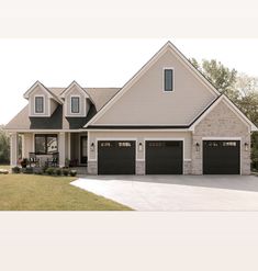 a large house with two garages and three windows