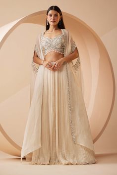 Roqa | Abida Off-White Lehenga And Cape Set | INDIASPOPUP.COM Trendy Lehenga Blouse Designs, Lehenga Designs For Teens, Indian Designer Suits Party Wear, Lengha Ideas, Sangeet Dress, Cape Lehenga, Pearl Border, Cutdana Embroidery, Cancan Lehenga