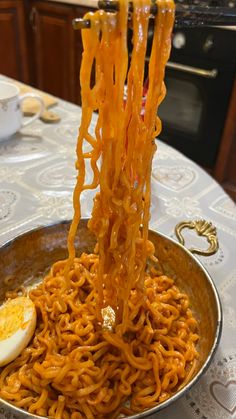 noodles and an egg are being served in a bowl