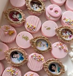 there are many pink and gold buttons with pictures in the holes on them that look like they were made out of candy