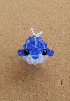 a small blue beaded object sitting on top of a table