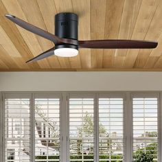 the ceiling fan is hanging from the wooden ceiling