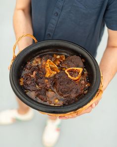 a person holding a bowl filled with food