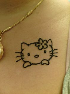 a hello kitty tattoo on the back of a woman's neck