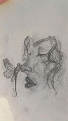 a drawing of a woman's face with a dragonfly on her nose