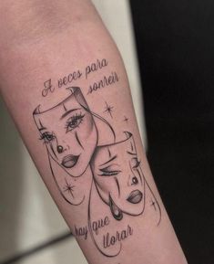 a woman's arm with two faces and words on it