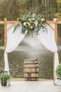 an outdoor ceremony setup with flowers and greenery