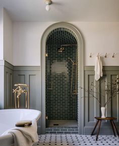 a white bath tub sitting next to a walk in shower