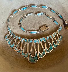 Gorgeous Taxco 925 sterling silver turquoise inlay Mexican bib necklace  Measures: 17 inches long by 1 1/2 inches at its widest point and weighs 60 grams  Marked: Taxco Mexico AMC and the TAXCO Sterling Silver registration number absolutely beautiful!! Unique Polished Turquoise Necklace, Unique Blue Necklace With Inlay, Elegant Turquoise Necklace With Inlay, Elegant Turquoise Inlay Necklace, Southwestern Blue Necklace With Inlay, Southwestern Turquoise Inlay Necklace, Southwestern Blue Inlay Necklace, Southwestern Style Blue Inlay Necklace, Collectible Blue Inlay Necklace