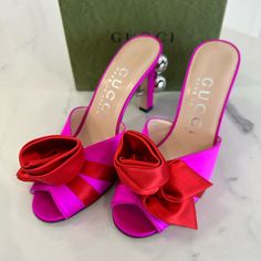 Brand New In Box. 100% Authentic Gucci Rose Ball Sandals Size 36 Style 699456 F1430 007 5680 Color- Pure Fuscia/ Rose Sandals By Gucci In Silk Satin With Rose Detail And Silver Spheres. - Gucci Love Parade Collection - Satin Rose On The Front - Silver Spheres With Gg Motif Applied On The Heel - Features Rounded Toe - Coated Stiletto Heel (9. 5cm) - Leather Sole - Made In Italy Comes Exactly As Shown In Photos. Includes Box, Dustbags And Papers Elegant Red Gucci Sandals, Luxury Pink High Heel Sandals, Gucci Party Sandals, Gucci Sandals For Summer Party, Gucci Summer Party Sandals, Luxury Pink Sandals With Wrapped Heel, Luxury Pink Sandals With Padded Heel, Gucci Heels For Spring Party, Spring Gucci Heels For Party