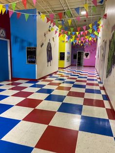 an empty school hallway with colorful flags and decorations on the ceiling, painted in bright colors