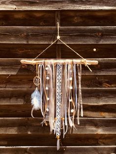 a dream catcher hanging from a wooden wall