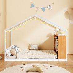 a child's bedroom with a white bed frame and lights on the wall above it