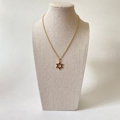 This elegant Star of David pendant features 24 round genuine Bohemian garnets, set in 900 silver with gold vermeil. Measures approx 21mm in length and 18mm in width, not including bale. The item listed here is old stock from a defunct jewelry business. Great condition unless otherwise noted. Please keep in mind that computer monitors vary & I do my best to provide an accurate representation of the colors of the items listed. Please note chain not included. Elegant Star-shaped Brass Jewelry, Elegant Brass Jewelry With Star Charm, Vintage Gold Star Jewelry, Classic Star Of David Jewelry For Gift, Classic Star Of David Necklace As Gift, Classic Star Of David Necklace For Gift, Classic Star-shaped Necklace As Gift, Classic Star-shaped Necklace For Gift, Brass Star-shaped Jewelry Gift