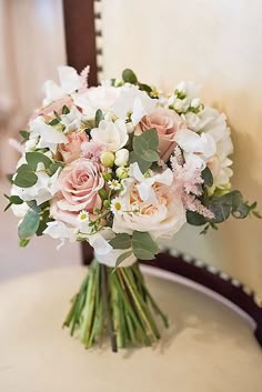 a bouquet of flowers sitting on top of a chair