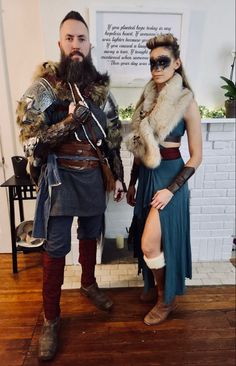 two people dressed in costumes standing next to each other