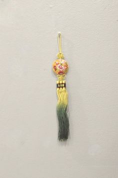 This is a beautiful Korean Norigae or embroidered tassel, which is Korean accessory that is hung from a women's coat strings or skirt. The norigae's function as a decorative pendant is both a good-luck charm hoped to bring something such as eternal youth, wealth or many sons (depending on its shape), as well as a fashion accessory. Usually, the Norigae from the parents' or in-laws' home was passed down to descendants. These decorative tassels come in a variety of shapes, colors and sizes and are dervi from nature or everyday life. A wonderful item to adorn your home or add to your collection. Shows Natural Age and Wear 13.5 Inches Long 16.5 Inches Long from Loop to Bottom AT BACARA WE STAND BEHIND ALL OF OUR MERCHANDISE. FULL MONEY BACK GUARANTEE WILL BE PROVIDED FOR DISSATISFIED CUSTOMERS Decorative Tassels, Korean Accessories, Eternal Youth, Silk Accessories, Luck Charm, Handmade Clothing, Luck Charms, Descendants, Handmade Clothes