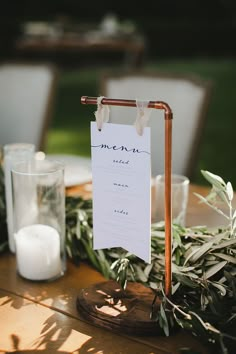 a table with candles and menu cards on it