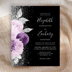 an elegant wedding card with purple flowers and silver glitters on the front, black background