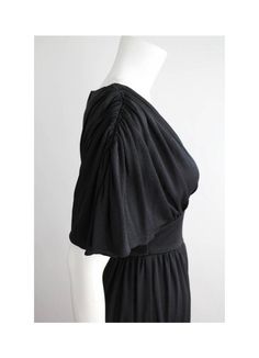 "Gorgeous draped goddess gown from the 1970's. Constructed of nylon jersey with a medium weight and soft hand. Features a v-shaped neckline with gathers at the bodice and sleeves, banded waist, and waistband that ties at the back. The bodice has a fitted underlayer with the sleeve draped over it. Sleeves are sloped at the shoulders. Center back zipper closure.  DETAILS Condition: More than excellent! Freshly laundered and ready to wear.  Label + Era: n/a; 1970s Fabrication: 100% Nylon Color: Bla Vintage V-neck Maxi Dress For Evening, Solid Color V-neck Dress With Gathered Sleeves, V-neck Maxi Dress With Gathered Waist For Daywear, Vintage V-neck Evening Maxi Dress, Formal V-neck Maxi Dress With Gathered Sleeves, Fitted Maxi Dress With Draped Sleeves And V-neck, V-neck Maxi Dress With Gathered Sleeves For Evening, Fitted V-neck Maxi Dress With Draped Sleeves, Black Pleated V-neck Maxi Dress