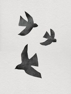 three black birds flying in the sky