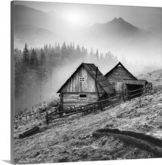 black and white photograph of an old cabin in the mountains