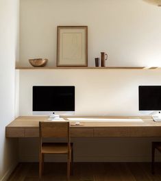 two computer desks sitting next to each other on top of a hard wood floor