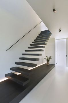 a modern staircase with black and white steps