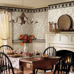 a dining room table is set with plates and flowers