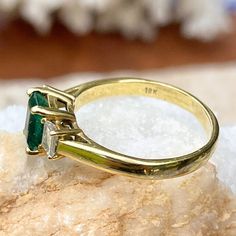 Vintage/ antique 18KT yellow gold emerald-cut Colombian emerald + diamond accent ring. Absolutely stunning and high quality ring which would be fantastic as an engagement, birthstone, or celebration piece. Size 9 Can be resized for an additional fee 1.25 CT plus natural, Colombian emerald Emerald measures: 7mm x 5.3mm Inclusions in stone, but deep color and saturation 2 natural, emerald-cut, natural diamonds VS clarity; H color diamonds .50 CTW diamonds Weight: 4.65 grams Estate condition. 1 Sid Emerald Cut Three Stone Birthstone Ring, Heirloom Emerald Cut Birthstone Ring With Prong Setting, Heirloom Birthstone Ring With Emerald Cut, Gift Emerald Ring With Three Stones In Radiant Cut, Gold Emerald Ring With Radiant Cut And Prong Setting, Anniversary Radiant Cut Emerald Ring, Radiant Cut Emerald Anniversary Ring, Classic Gold Emerald Ring With Radiant Cut, Gold Emerald Ring With Radiant Cut