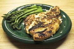 grilled chicken and asparagus on a green plate