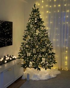 a decorated christmas tree with lights in a living room